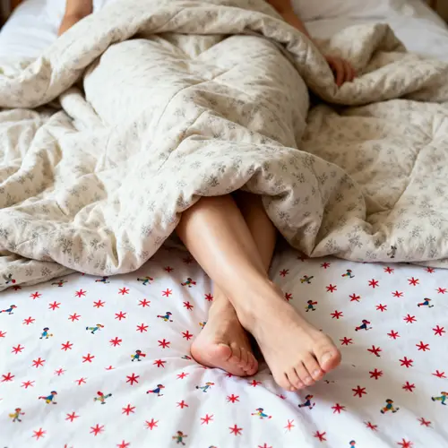 Close-Up of Bare Feet on Cozy Bed