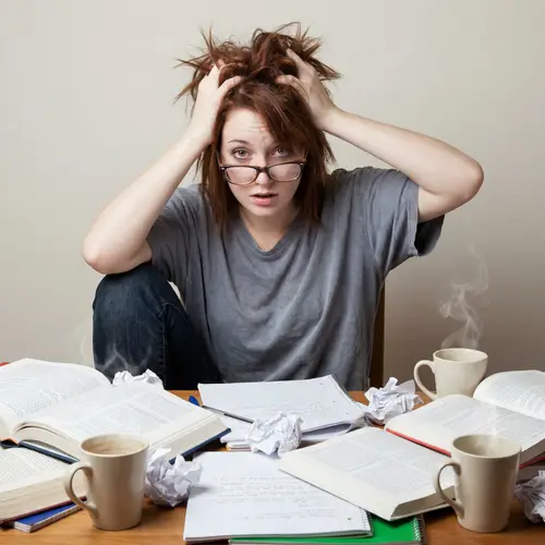 Distressed Young Woman at Overloaded Workspace