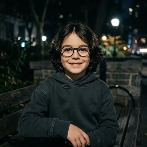 Charming Young Caucasian Boy in Dark Mode with Wavy Hair and Glasses