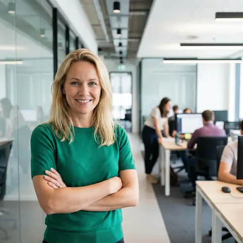 Blonde Woman in Green T-Shirt | Businesswoman Smiling in Office