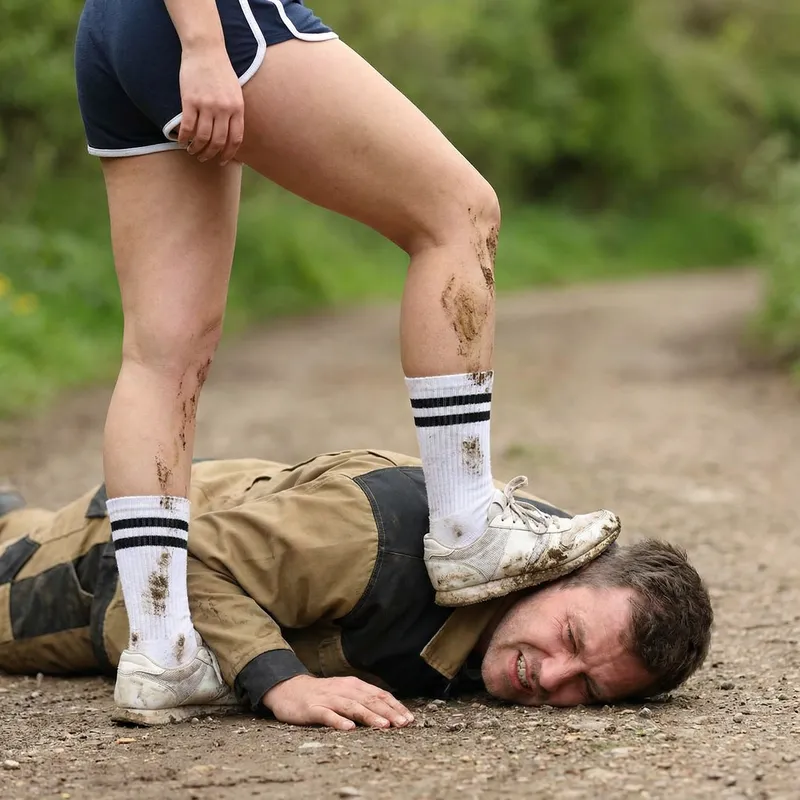 Women in Tennis Socks Trampling a Man's Face