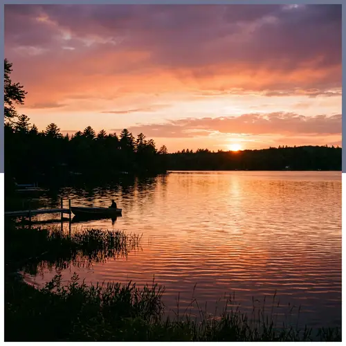 Tranquil Sunset Scene Over Lake with Silhouetted Trees