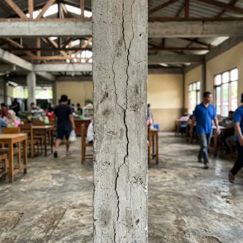 Close-Up Perspective of Damaged Concrete Column in One-Story Building
