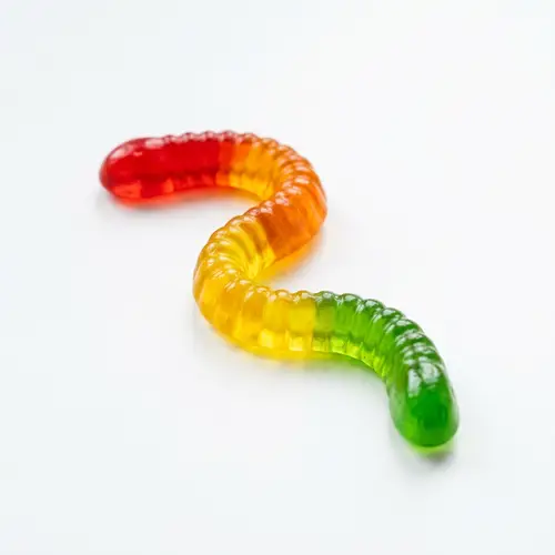 Vibrant Gummy Worm Candy on White Background