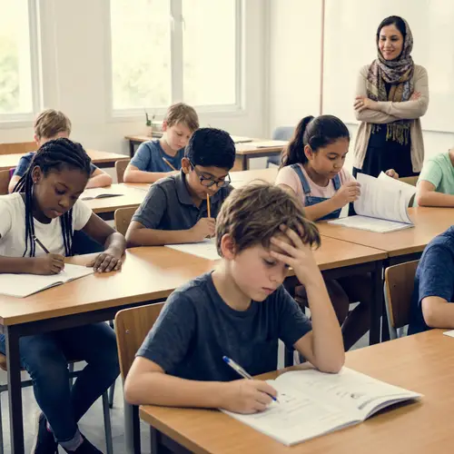 Diverse Group of Children Concentrating in Classroom