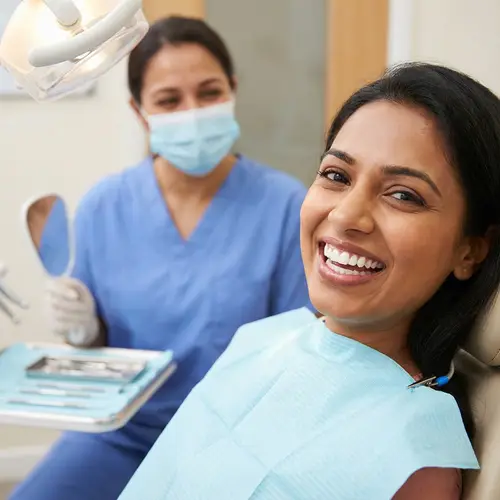 South Asian Woman with Perfect Smile in Dental Clinic