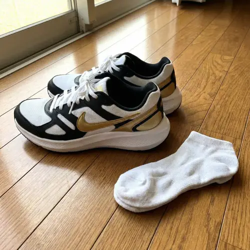 Sleek White Running Shoes with Gold Accents | Nike