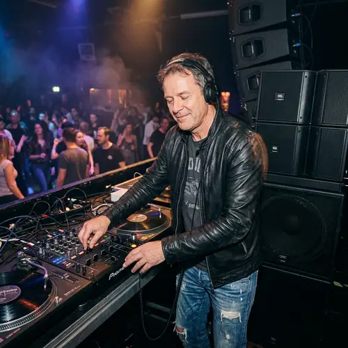 Professional DJ Mixing Tracks with Passion on Turntable