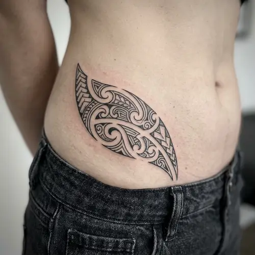 Tribal-Inspired Cover-Up Tattoo Below the Waistline