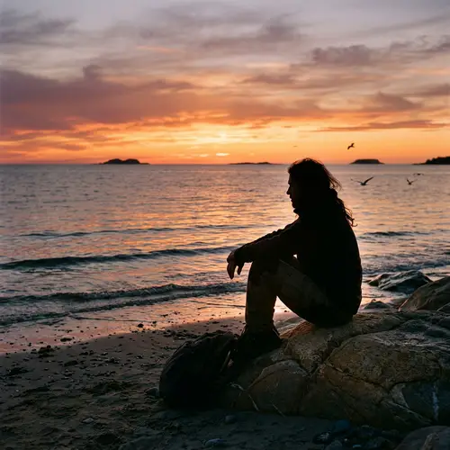 Tranquil Sunset Scene: A Man Reflecting by the Calm Sea