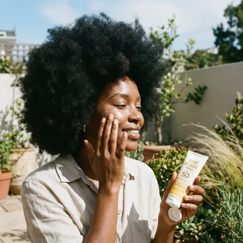 Black Woman Applying Sunscreen: Self-Care Beauty Routine