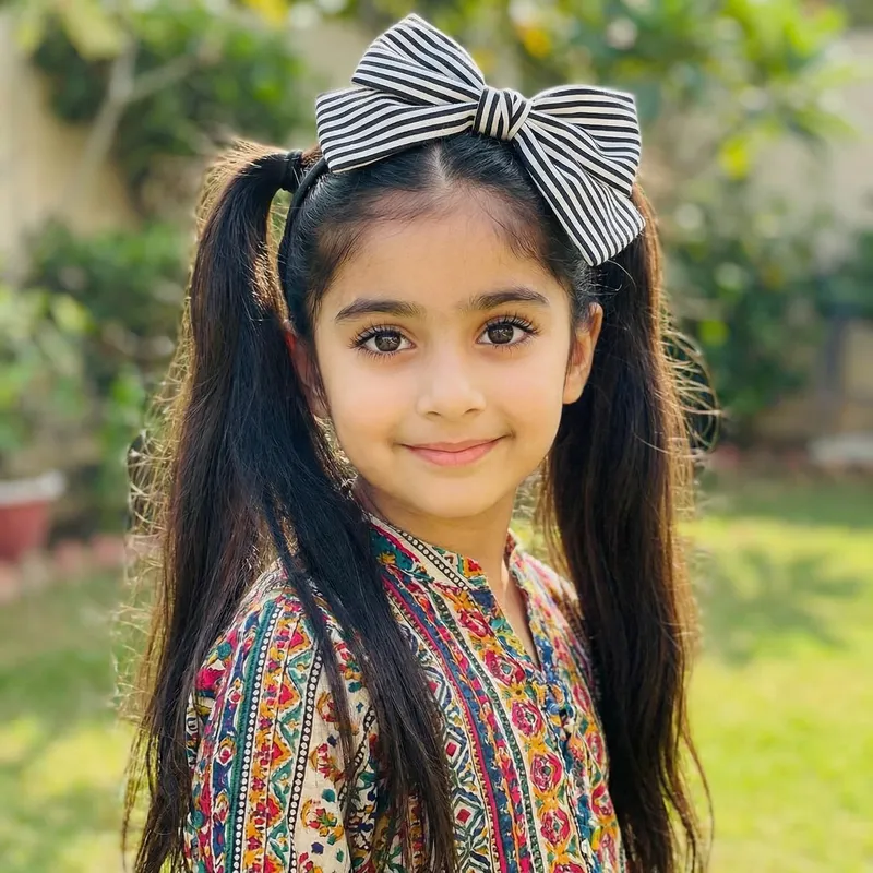 Cute Girl with Long Black Hair, Big Bow, and Stunning Eyes