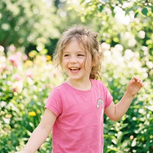Playful Portrait of a Young Girl in Vibrant Pink T-Shirt