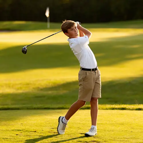 Young Golfer Perfecting His Swing