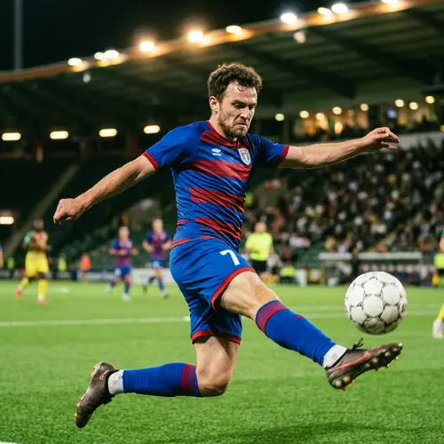 Dynamic Soccer Player in Blue and Red Kit | Stadium Lights