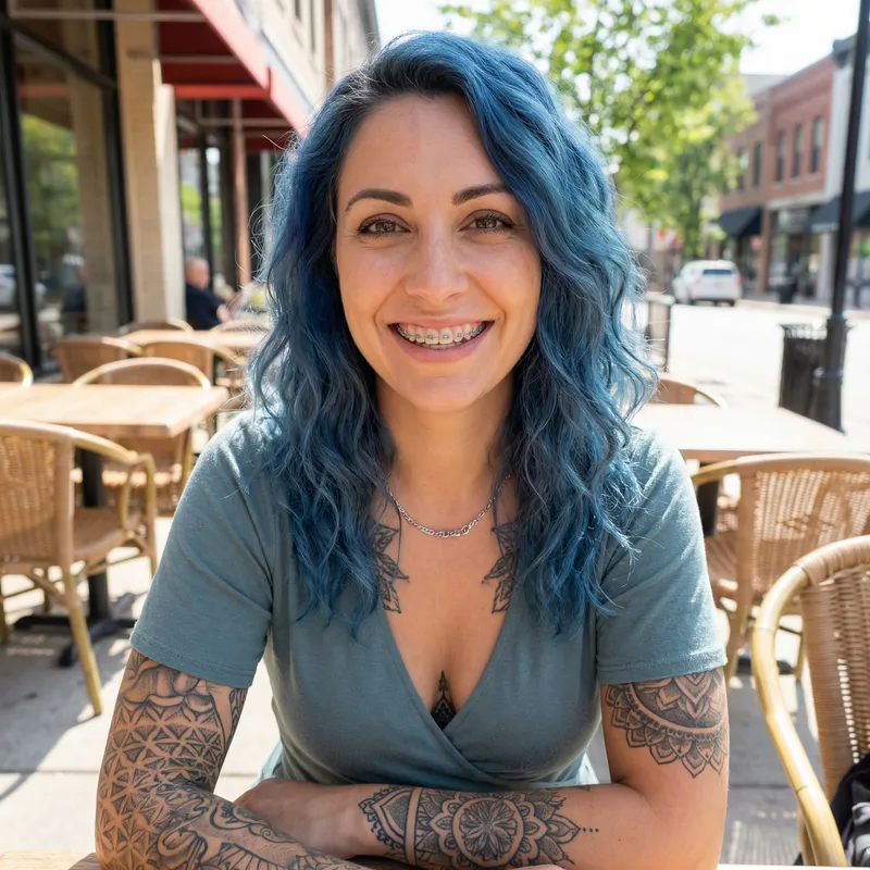 Confident Smiling Woman with Blue Hair and Tattoos