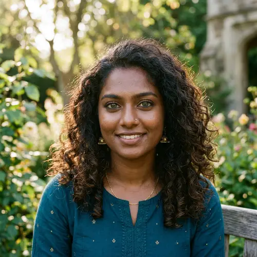 South Asian Woman with Deep-Set Green Eyes and Curly Hair