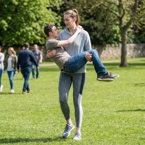 Strong Woman Lifts Man - Empowering Moments