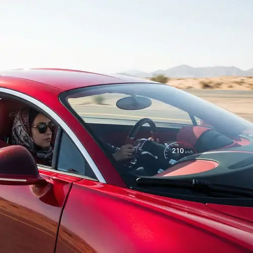 Middle-Eastern Woman in Hijab Drives Luxury Sports Car on Open Highway