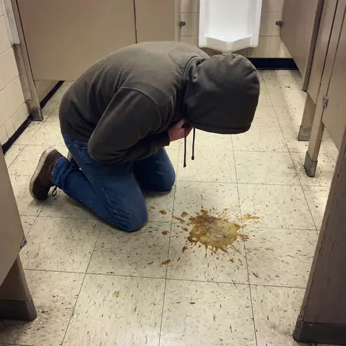 Person Vomiting on Floor: Causes and Solutions
