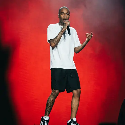 Skinny Rapper in White Shirt and Black Shorts