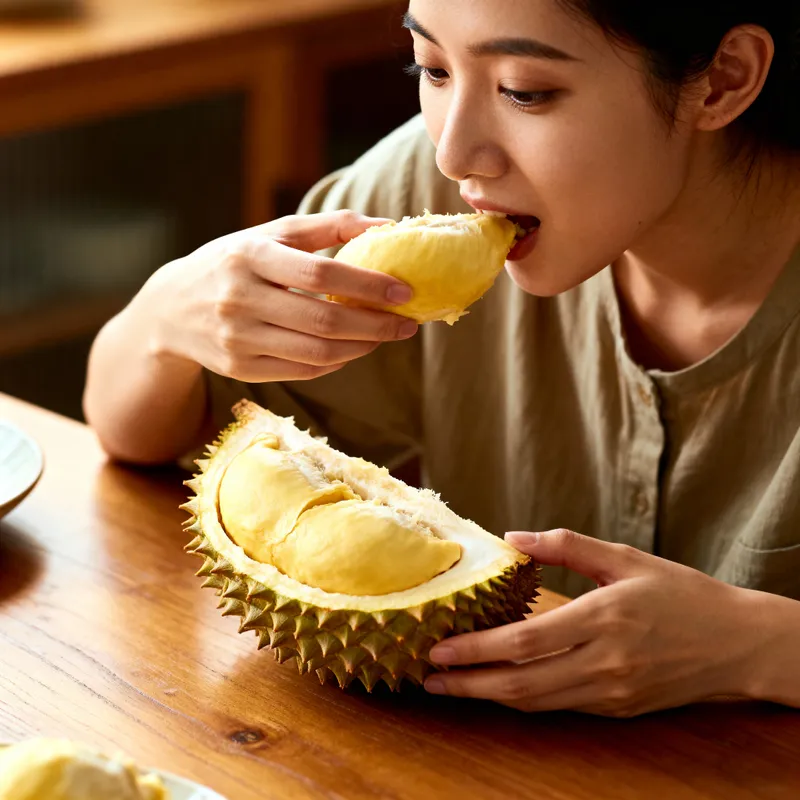 Lady Enjoying Durian at the Table