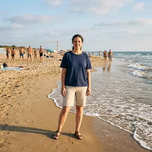 Relaxing Afternoon Beach Scene with Woman Standing by the Sea