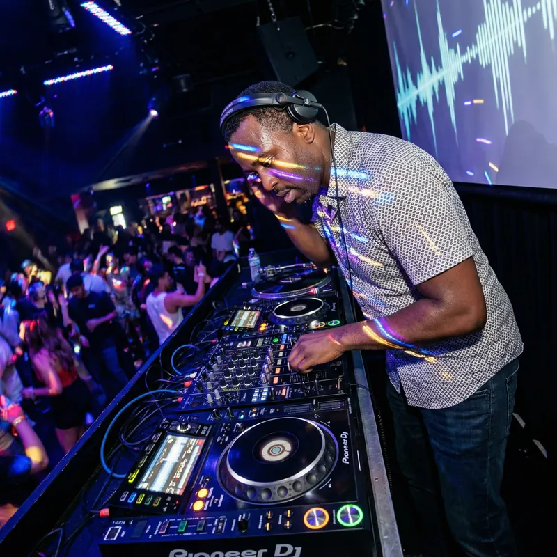 Black DJ on Turntables: Unforgettable Club Experience