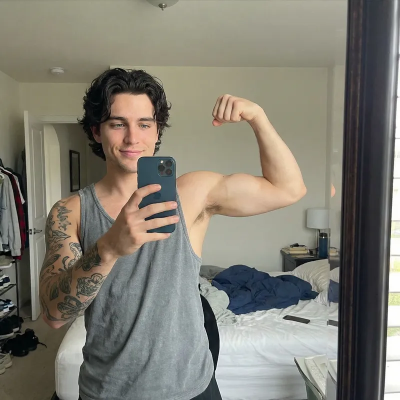 Handsome 22-Year-Old Man with Tattoos and iPhone