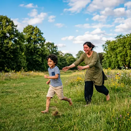 Cheerful South Asian Boy and Mother Playing in Grassy Field