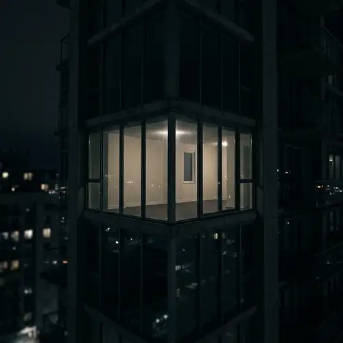 Solitary Glass Apartment in a High-Rise at Night
