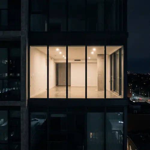 Mysterious Glass Apartment in High-Rise at Night