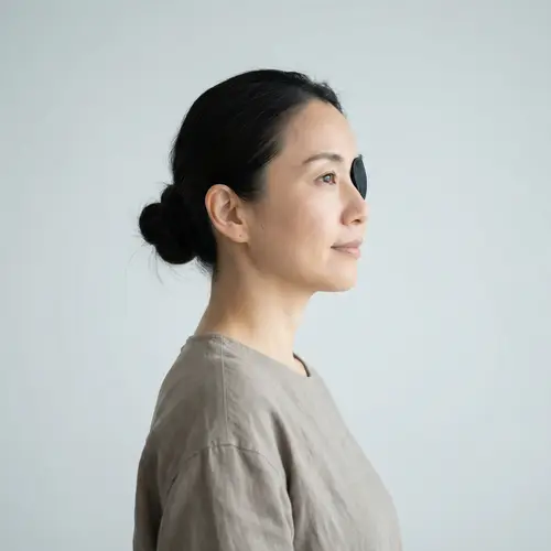 Asian Woman in 40s with Black Eyepatch | Serene Profile View