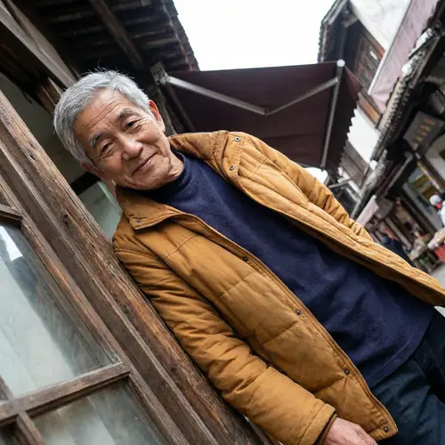 Expressive Elderly Asian Man in Traditional Attire