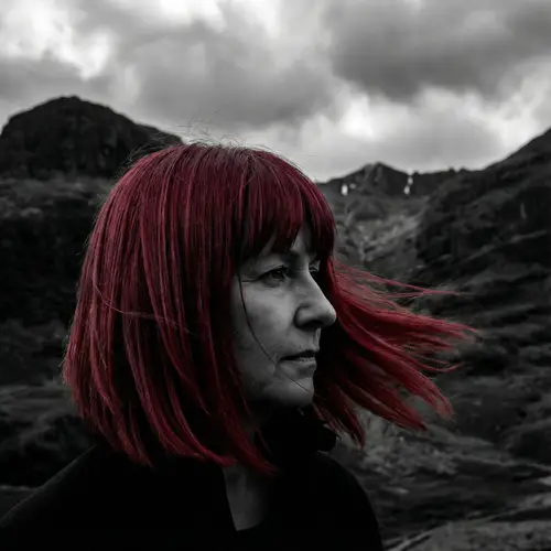 Dramatic Black & White Portrait of a Middle-Aged Woman with Vibrant Red Hair