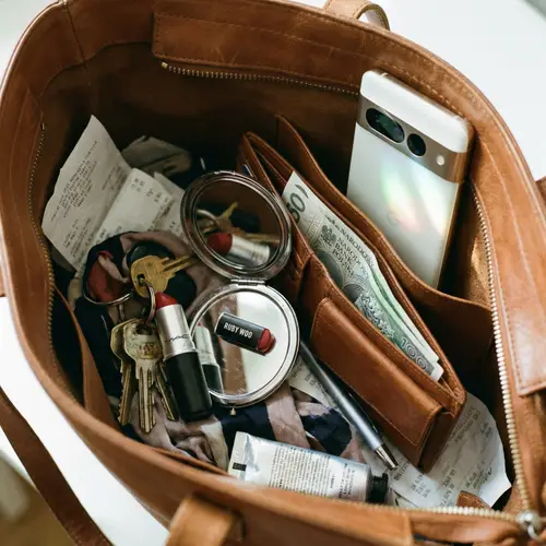 Woman's Purse Essentials: Keys, Lipstick, Mirror, Wallet, Smartphone