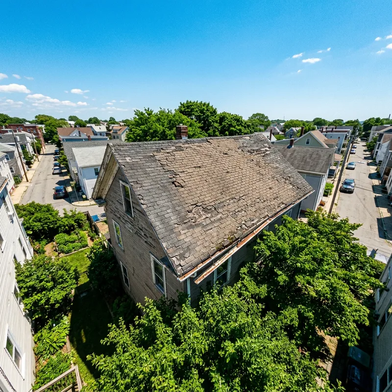 Urgent Roof Repairs Needed: Sun-Damaged Fresno Roof Viewed by Drone