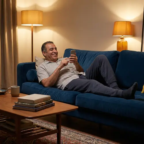 Relaxed Middle-Eastern Man Lounging with Smartphone