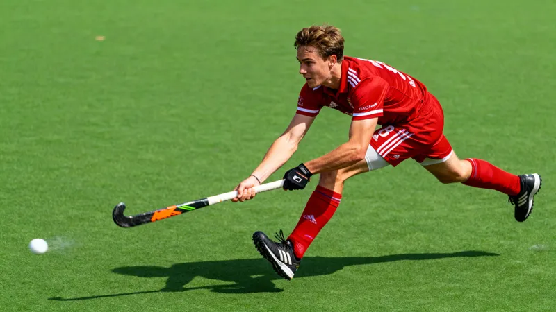 Dynamic Field Hockey Action Shot in Red Jersey Dynamic Field Hockey Action Shot in Red Jersey