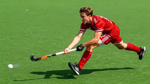Dynamic Field Hockey Action Shot in Red Jersey