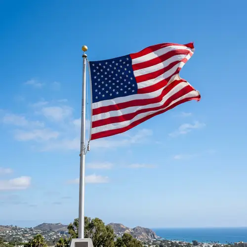 Flag Fluttering in the Wind against Blue Sky