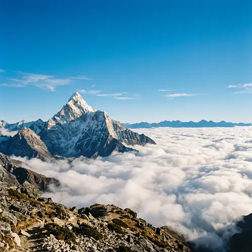Tranquil Mountain Peak Amidst Gentle White Clouds