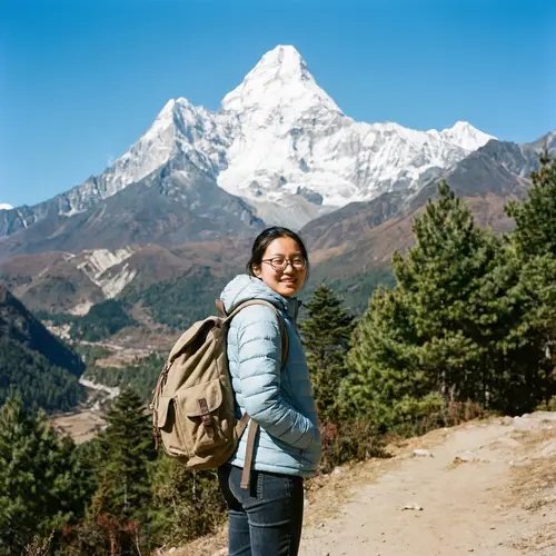 Asian Female Student Backpacking in Majestic Snow-Capped Mountain Scene