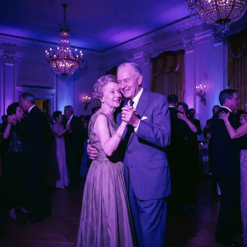 Elegant Dance: Senior Couple in Violet Lighting