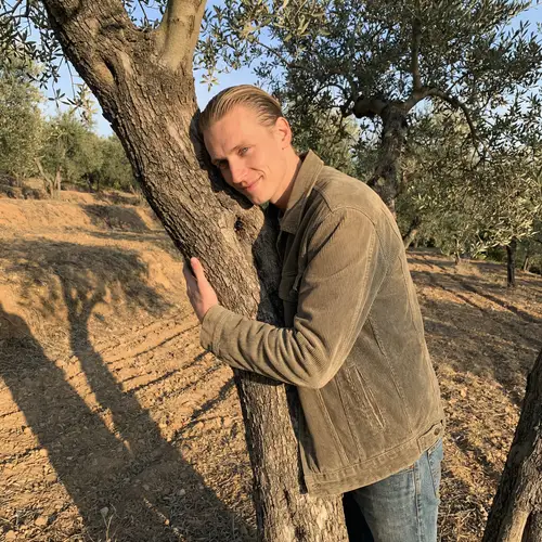 Affectionate Man Kissing Olive Tree - Portrait of Raul Morales