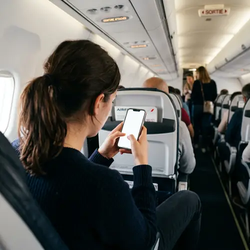 Woman on French Plane Using Phone