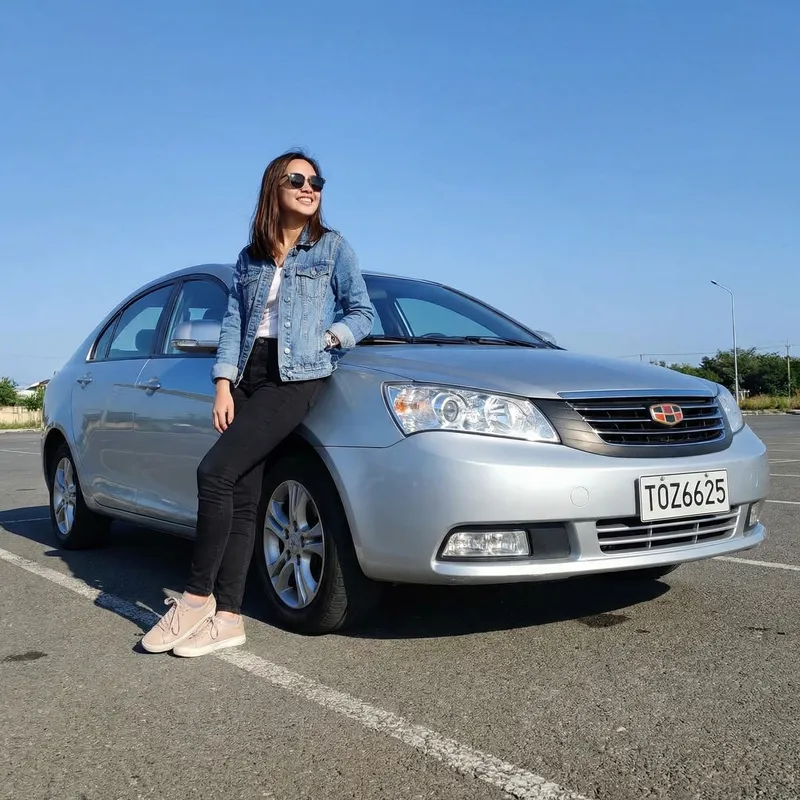 Portrait of a Girl Leaning on Silver Geely Emgrand Car | TOZ6625