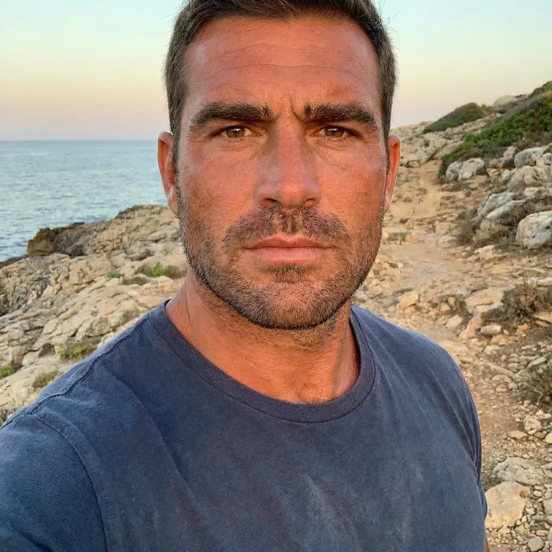 Salman Khan: Muscular Man in Blue Shirt