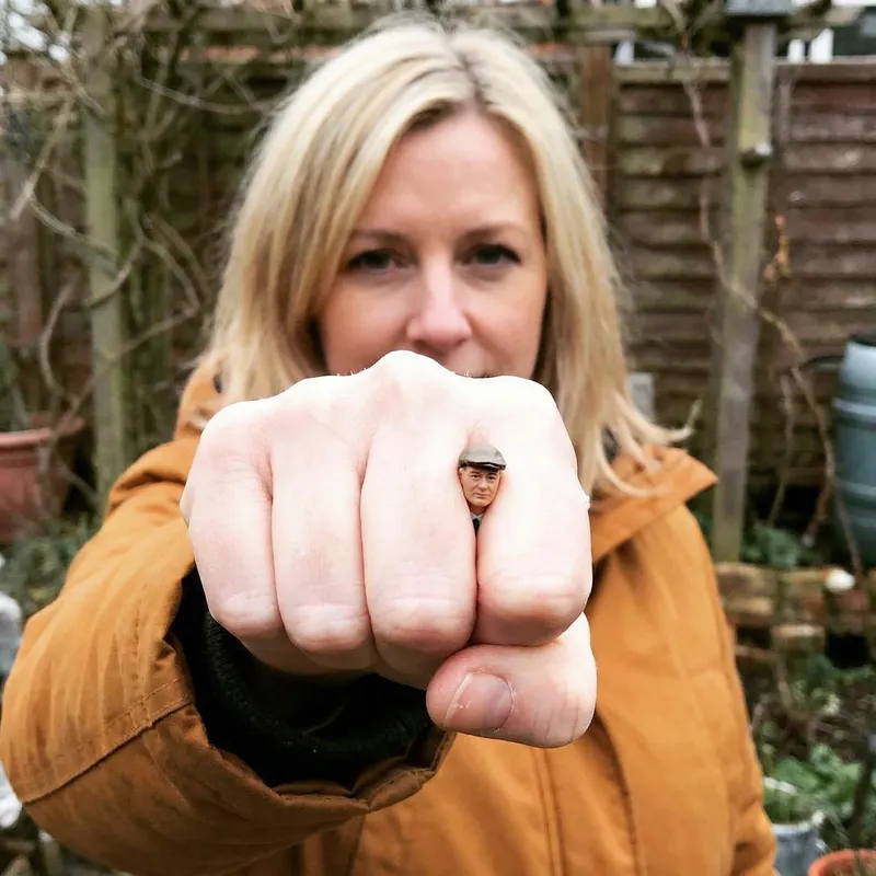 Blonde Woman Squeezing Tiny Man in Fist - Dominance Displayed