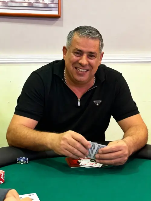 Poker Player at the Table with Cards